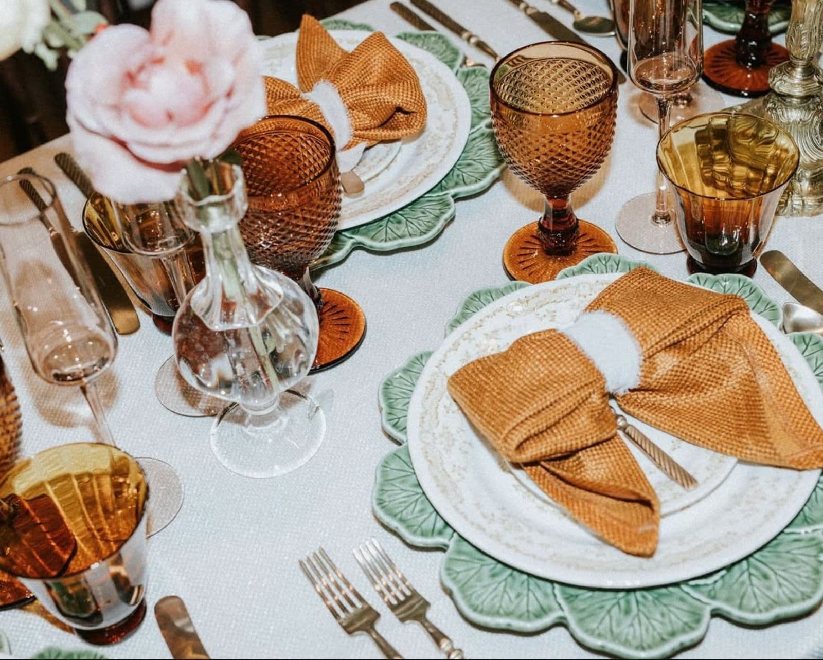 A table laid with coloured glassware and folded napkins