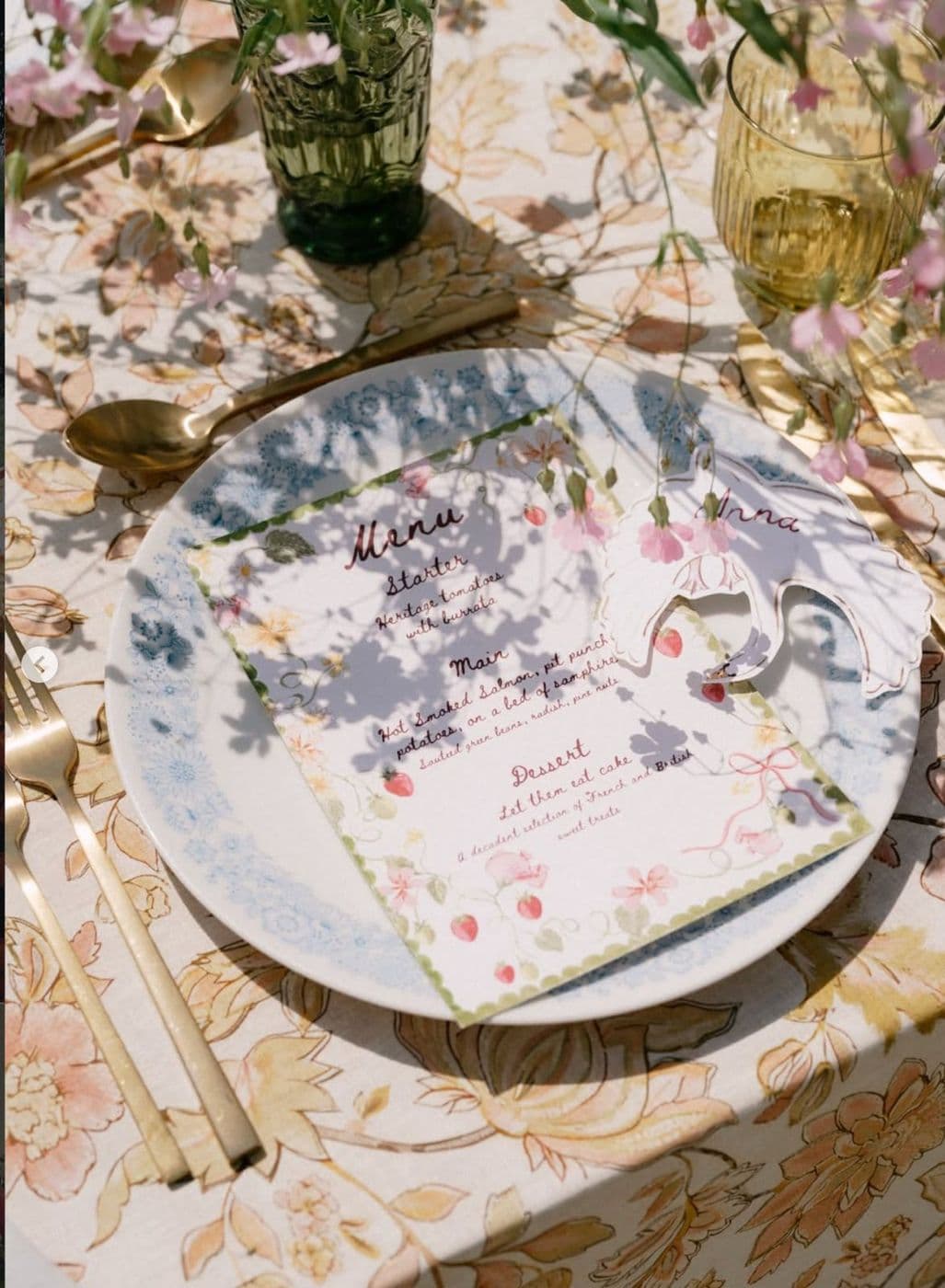 A floral place setting with a printed menu card