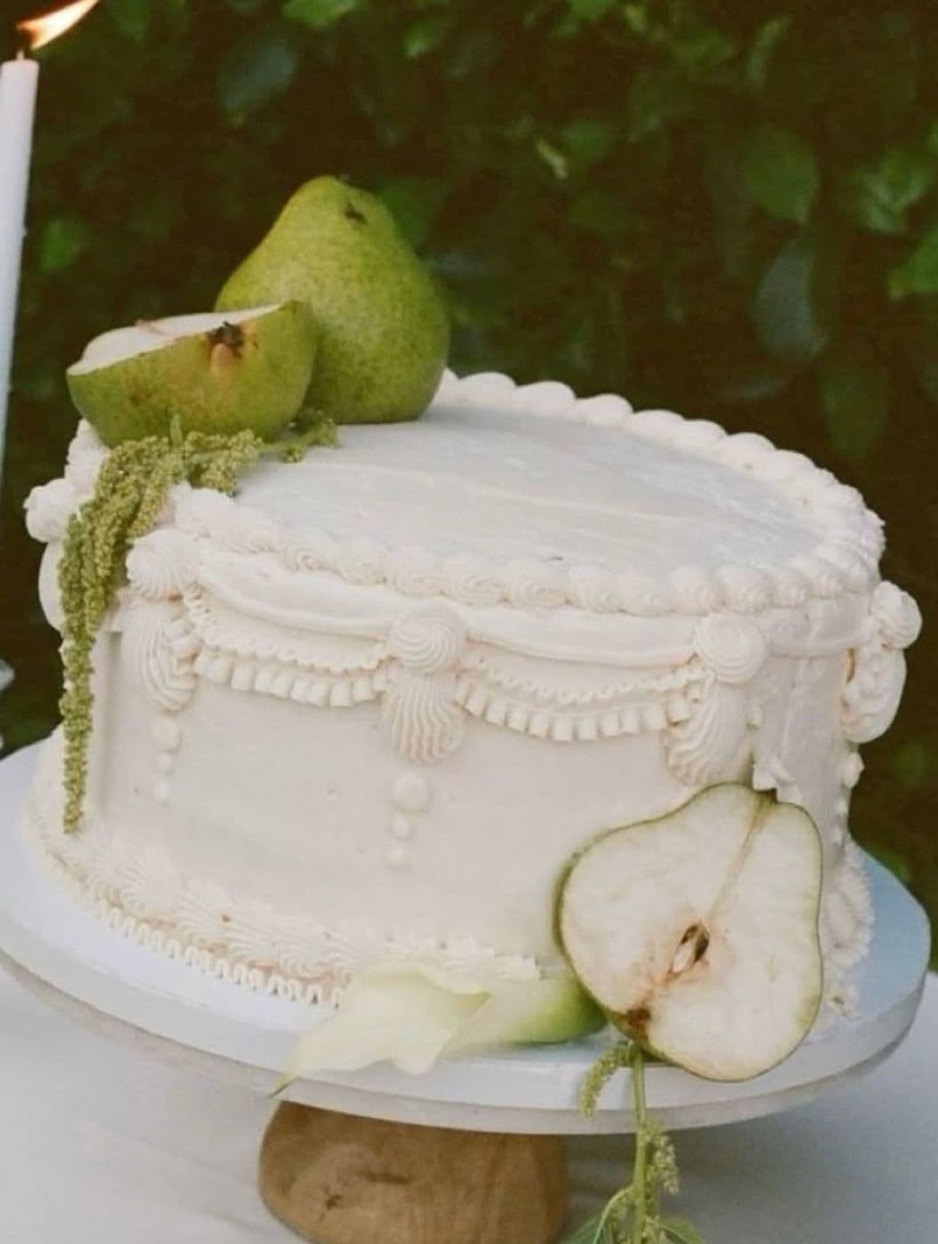 A white celebration cake decorated with pears